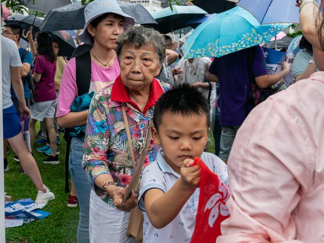 Pro-Beijing supporters hold Chinese national flags during a pro-government rally. Picture: Getty