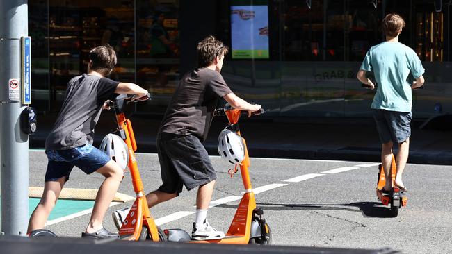 People riding escooters to go with a report about injuries sustained while riding them. Brisbane CBD Wednesday 3rd April 2024 Picture David Clark