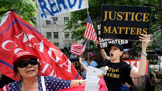 Supporters and opponents of former US president and Republican presidential candidate Donald Trump scuffle as they wait for a verdict in Trump's hush money criminal trial outside Manhattan Criminal Court on May 29. Picture: Timothy A. Clary, via AFP