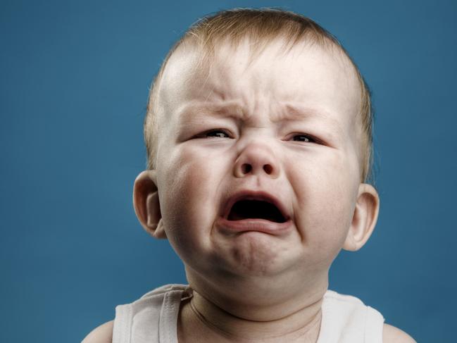 Photo of nine month baby crying, isolated. istock image