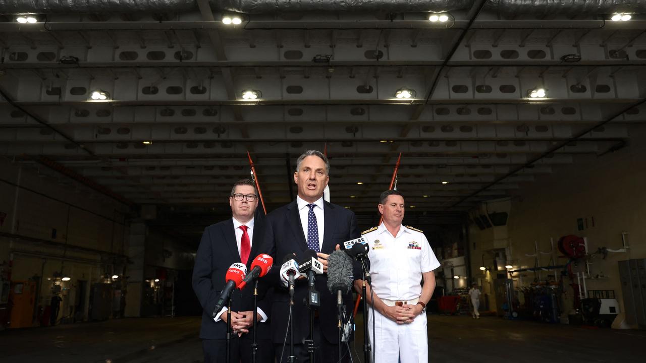 Australia’s Defence Minister Richard Marles speaks with Minister for Defence Industry to his left Pat Conroy and Australian Navy Chief Mark Hammond aboard the Australian Navy ship HMAS Canberra in Sydney on February 20, 2024. Picture: David Gray/AFP
