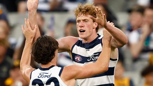 MELBOURNE, AUSTRALIA - APRIL 01: Gryan Miers (left) and Toby Conway of the Cats celebrate a goal during the 2024 AFL Round 03 match between the Hawthorn Hawks and the Geelong Cats at the Melbourne Cricket Ground on April 01, 2024 in Melbourne, Australia. (Photo by Michael Willson/AFL Photos via Getty Images)