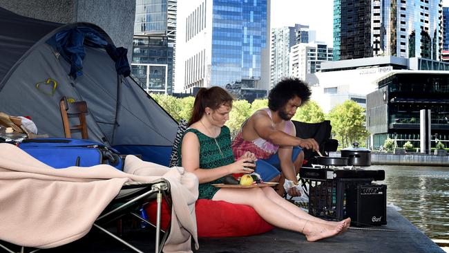 Selina, 22, and Mark cook lunch on their camping stove set up with their tent at Enterprize Park. Picture: Nicole Garmston