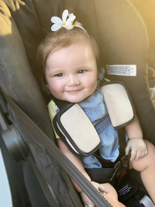 Ayla Phillips on the way home from dad’s work after picking some flowers for her and mum’s hair. Picture: Sariah Muggeridge
