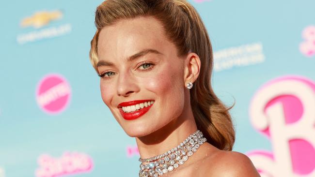 (FILES) Australian actress Margot Robbie arrives for the world premiere of "Barbie" at the Shrine Auditorium in Los Angeles, on July 9, 2023. Hollywood's pink wave has yet to crest as Warner Bros.' "Barbie" dominated for a third straight weekend in North American theaters, pushing the film's global haul past $1 billion in a first for a solo woman director, industry watcher Exhibitor Relations said August 6. The Greta Gerwig-directed blockbuster has tapped into a cultural zeitgeist: not only did it make history by hitting the billion-dollar box office milestone, it also did so faster than any film -- including those directed by men -- in Warner Bros.' 100-year history, executives there said. (Photo by Michael Tran / AFP)