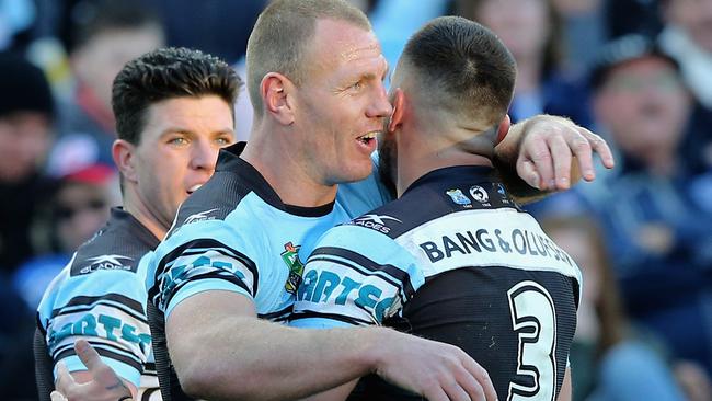 Luke Lewis of the Sharks celebrates a try.