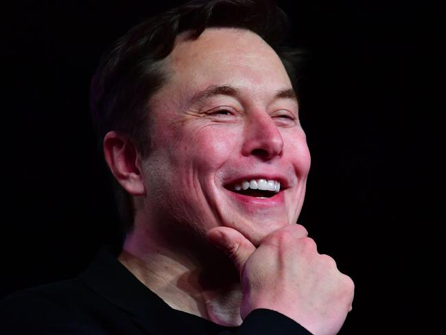 (FILES) In this file photo taken on March 14, 2019 Tesla CEO Elon Musk reacts during the unveiling of the new Tesla Model Y in Hawthorne, California. - Tesla's surging stock value has boosted Elon Musk further up the list of top billionaires as he stands poised for yet another massive payout as soon as this week. (Photo by Frederic J. BROWN / AFP)