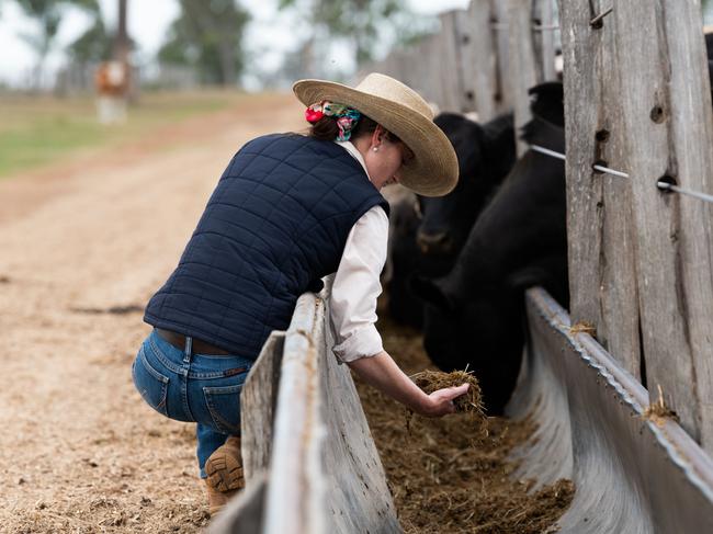 ROAM director of operations Georgie Mutton inspects a feedlot ration at a southeast Queensland feedlot. Picture: Rachel Lenehan