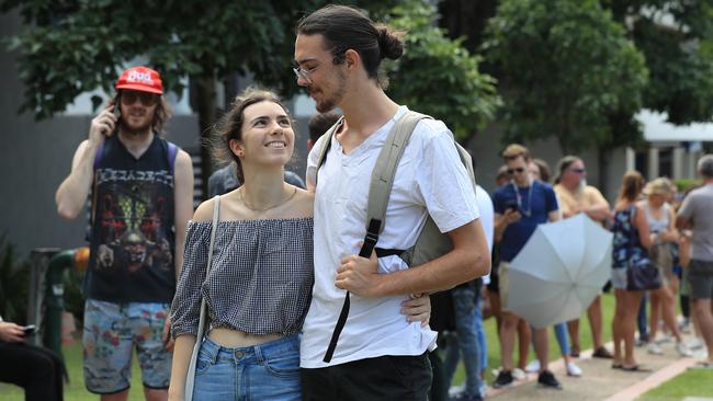 Will Mcalpin, 22, and Carla Christou, 20, from Labrador line up outside Southport Centrelink after losing their jobs. Picture: Adam Head