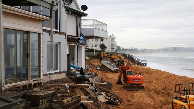 Emergency crews working on the houses on Collaroy Beach that were partially destroyed during the 2016 East Coast low. Picture: Tim Hunter.