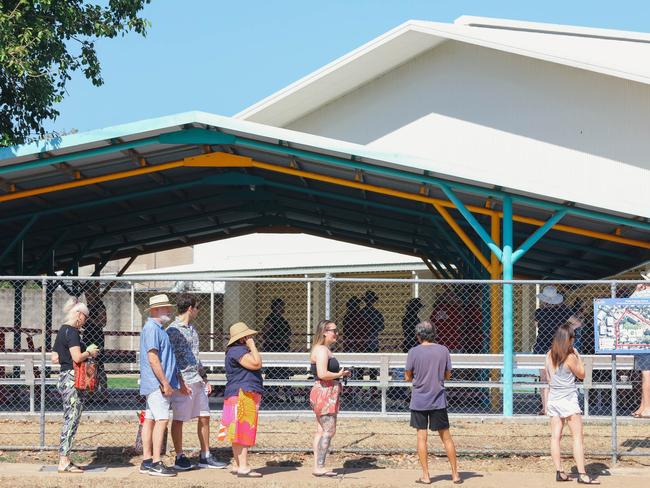 Voters on Saturday maintained social distancing as they lined up to cast their ballots for the Fannie Bay electorate. Picture GLENN CAMPBELL