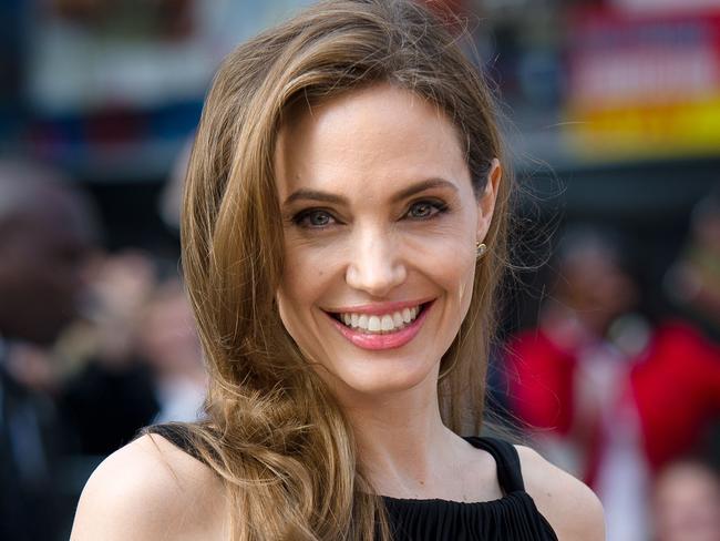 US actress and humanitarian campaigner Angelina Jolie poses as she arrives for the UK premiere of her US actor and fiance Brad Pitt's latest film "World War Z" in Leicester Square in central London on June 2, 2013. Jolie, 37, revealed in an article in the May 14 edition of The New York Times that she chose to undergo surgery to minimize the risk she might develop breast cancer due to the inheritance of a "faulty gene." The actress's partner and fellow screen star Brad Pitt led worldwide praise, declaring Jolie heroic, followed by her doctors, other stars and thousands of supporters, who took to social media to praise her openness. AFP PHOTO / LEON NEAL