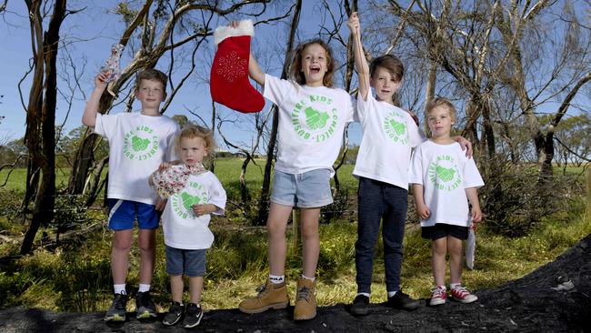 Sebastian Ascott of Woodside, 9, his brother Harrison, 3, with Bushfire Kids Connect friends Olive, 9, Eddie, 9 and Archie, 4. Picture: NCA NewsWire/Naomi Jellicoe