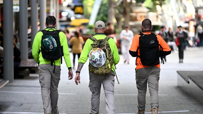 BRISBANE, AUSTRALIA - NewsWire Photos - AUGUST 31, 2022.Construction workers walk through Brisbane's CBD at the end of their work day. Queensland Education Minister Grace Grace has announced a new $10 million pilot program to boost the number of industrial technology and design (ITD) teachers, which will support tradies to become teachers in state schools.Picture: NCA NewsWire / Dan Peled