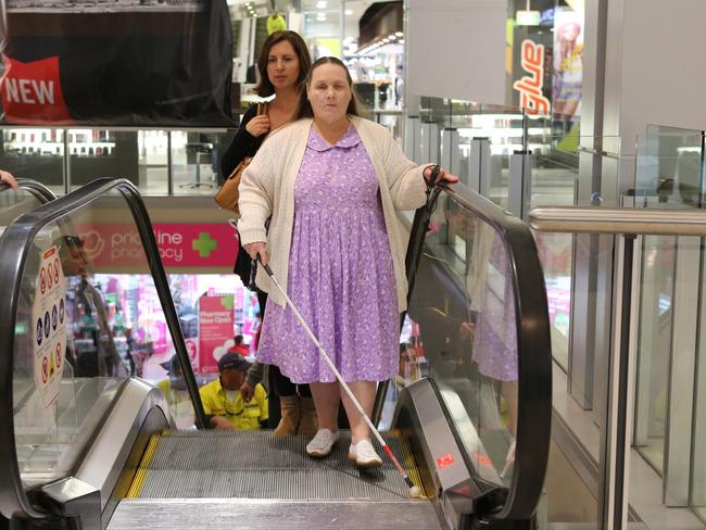 Orientation and mobility instructor Nicola Riley with a Colleen Thompson, providing training for using a long cane, being guided around Westfield Chatswood. Picture: Rohan Kelly