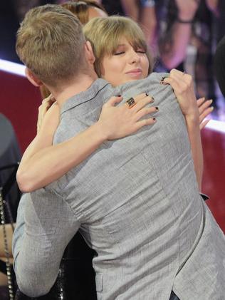 Taylor Swift hugs Calvin Harris at the iHeartRadio Music Awards. Picture: Jason Kempin / Getty Images