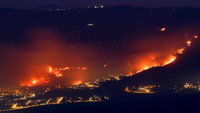 Fires burn as a result of rockets launched from Lebanon into northern Israel, next to the city of Kiryat Shmona near the Lebanon border.