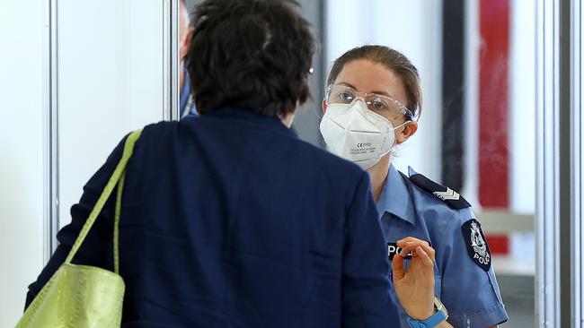 A traveller has their G2G pass verified by police at Perth Airport. Picture: Paul Kane/Getty Images