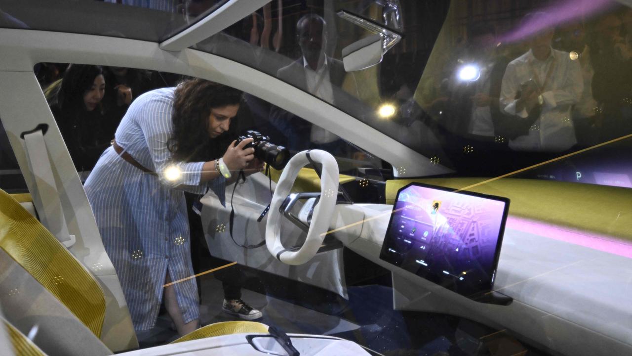 Visitors take pictures of the 'Neue Klasse' (New Class) in Munich. Photo: Tobias SCHWARZ / AFP