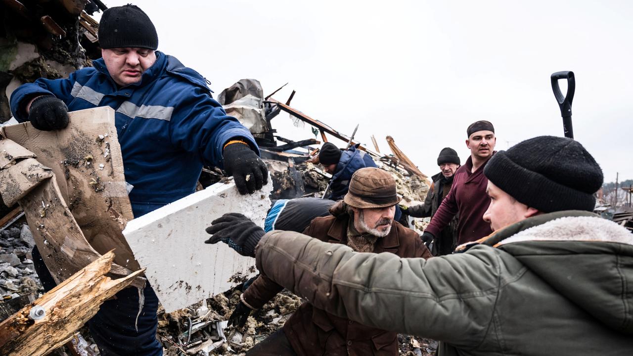 Local residents remove debris of a residential building. Picture: Reuters