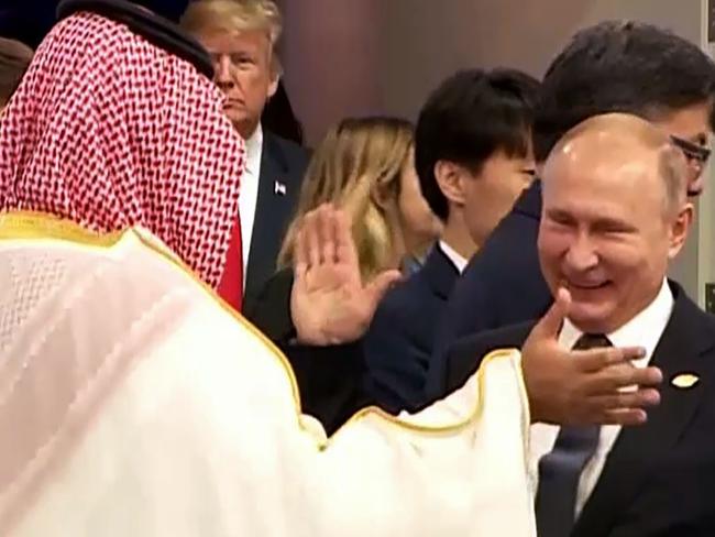 In this still image obtained from an Argentina G20 video, Russia's President Vladimir Putin (C) and Saudi Arabia's Crown Prince Mohammed bin Salman greet each other at the G20 Leaders' Summit in Buenos Aires, on November 30, 2018, as US President Donald Trump enter the room (C left rear). (Photo by HO / G20 ARGENTINA / AFP) / RESTRICTED TO EDITORIAL USE - MANDATORY CREDIT 
