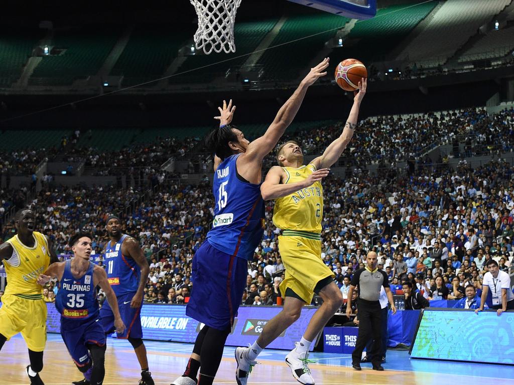 Australia's Nathan Sobey (R) lays-up against June Fajardo of the Philippines during their FIBA World Cup Asian qualifier game at the Philippine arena in Bocaue town, Bulacan province, north of Manila on July 2, 2018. Australia won by default 89-53. / AFP PHOTO / TED ALJIBE