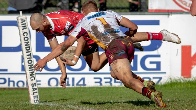 Blake Clayton scores in the corner for the Eagles as Thirlmere’s Hayden Sutton arrives too late. Pics by Julian Andrews.