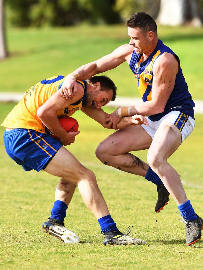 Gaza’s Damon Hill is tackled by PHOS Camden’s Aaron Bergsma. Picture AAP/Mark Brake