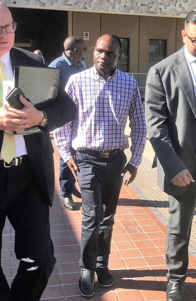 John Mugambi Mwamba walks out of Townsville Magistrates Court. Photo: Jacob Miley