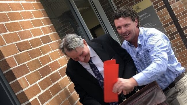 Denis Thomey (right) was all smiles outside court.