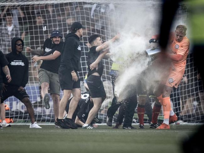 Fans stormed the pitch during a December match between Melbourne City and Melbourne Victory at AAMI Park.