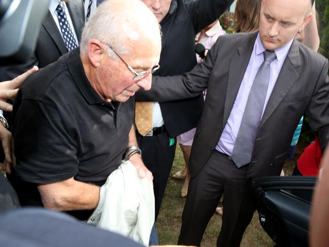 REAL ARREST: Rogerson is led away from his home by detectives.