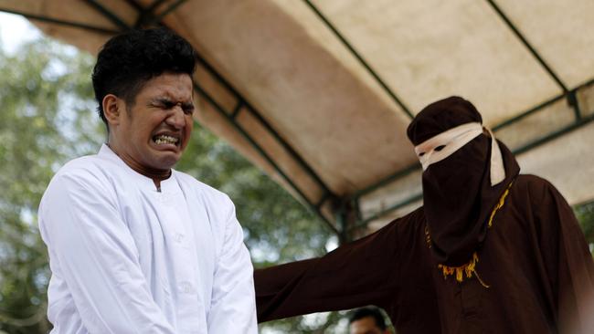 An Acehnese man is whipped in front of the public for violating sharia law in Banda Aceh, Indonesia, 27 February 2017. The man was caned for having unmarried sex. Picture: Hotli Simanjuntak.