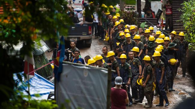 Lifting out: As many as 30 Thaui military teams are searching the mountain top over Tham Luang to find the exact spot above the boys so they can drill a chimney to winch them out. Picture: AFP