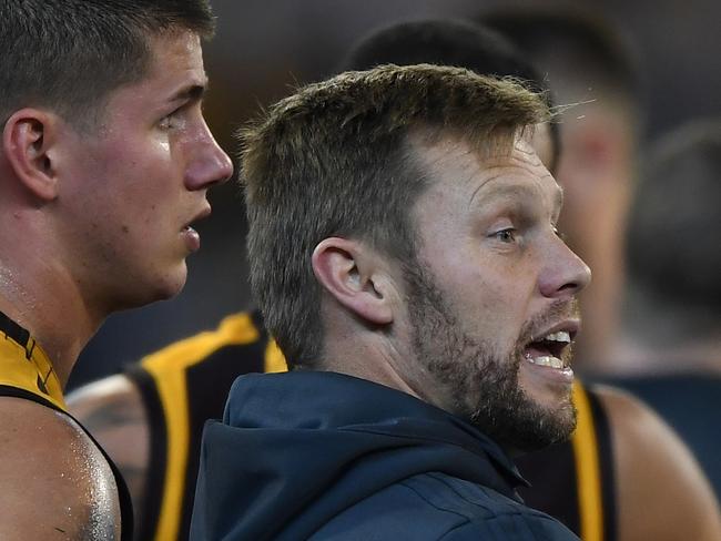 Hawks assistant coach Sam Mitchell (right) is seen during the Round 16 AFL match between the Hawthorn Hawks and the Collingwood Magpies at the MCG in Melbourne, Friday, July 5, 2019. (AAP Image/Julian Smith) NO ARCHIVING, EDITORIAL USE ONLY