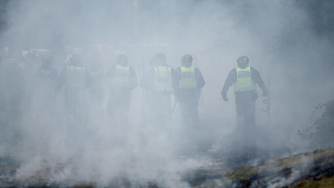 Riot police officers are seen through smoke as they patrol during anti-migration protests in Rotherham. Picture: Getty Images