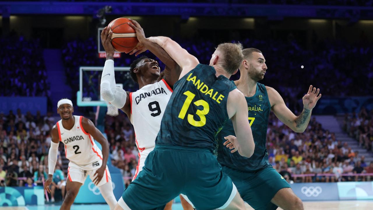 Jock Landale and Jack McVeigh defend hard against Canada’s RJ Barrett. Picture: Thomas Coex / AFP