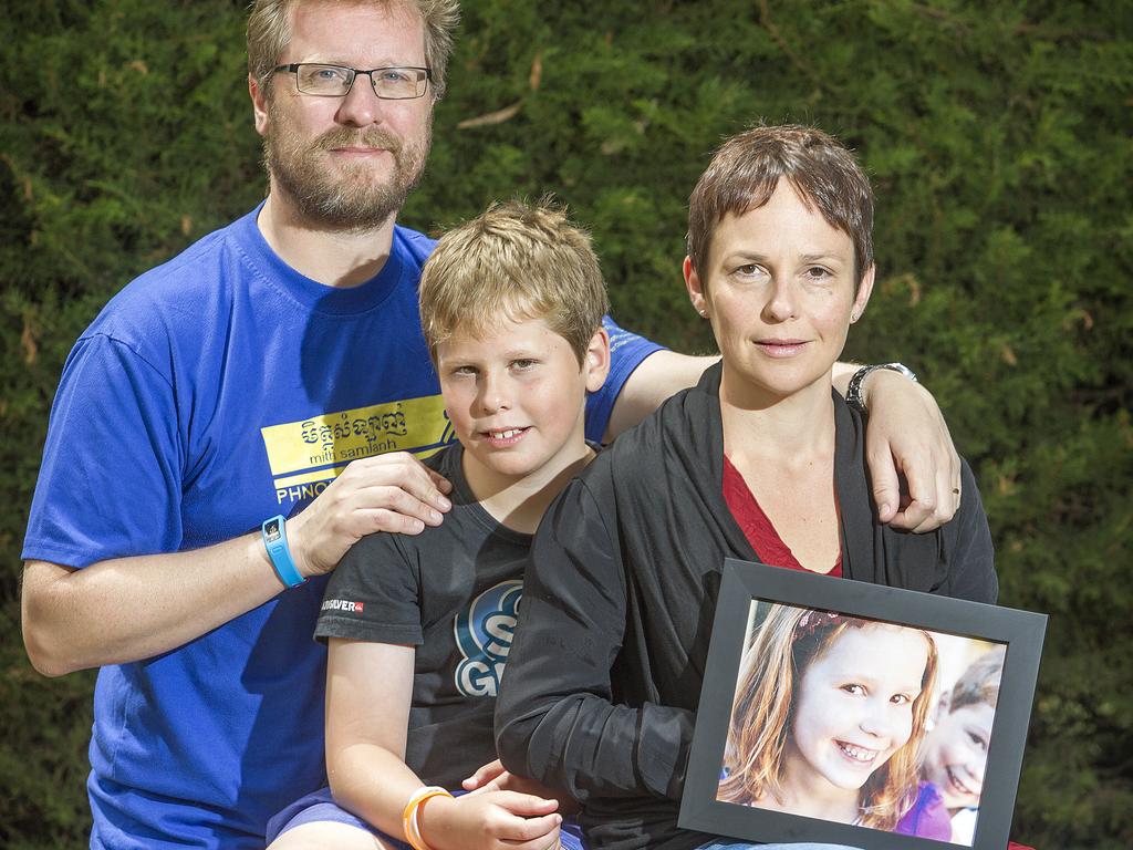 Victorian MP Jaala Pulford, with her husband Jeff, son Hamish and a Photograph of their daughter, Sinead who died shortly after her cancer diagnosis in 2014. Picture: Sarah Matray