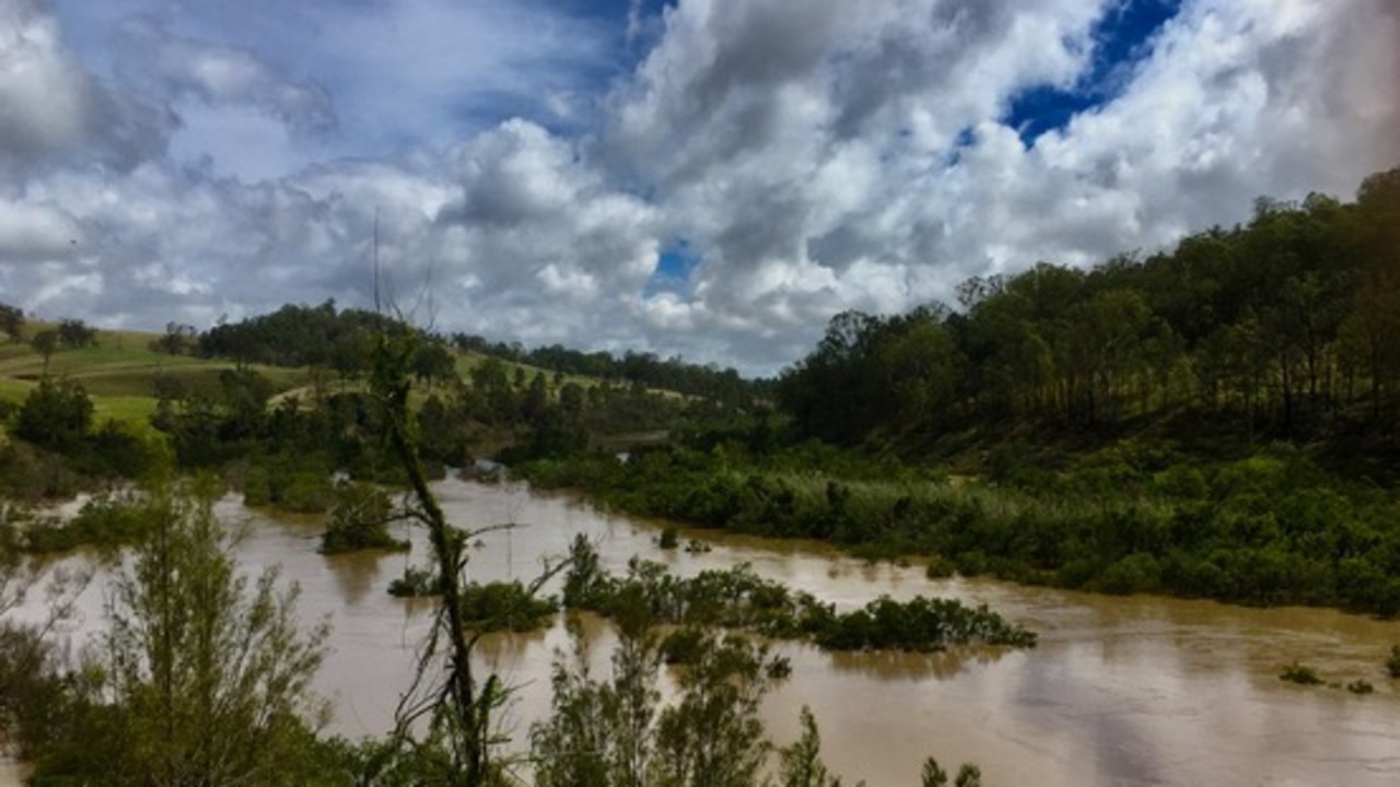 The swollen Mann River at its junction with the Clarence River (left).