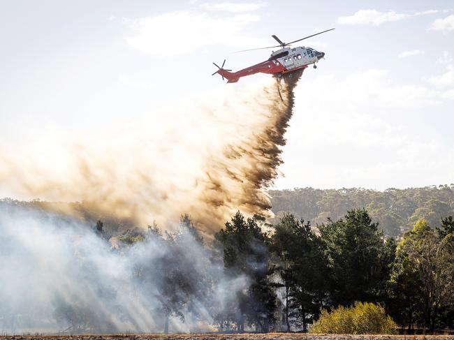 A water bomber mops up a spot fire in Beaufort. Picture: Mark Stewart