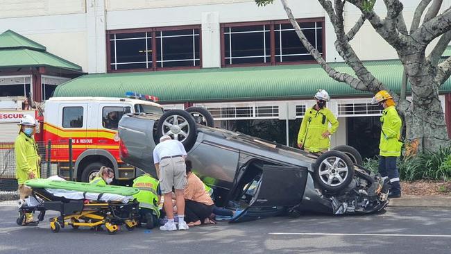 A car has flipped upside after a single vehicle crash on Bunda Street in Cairns City.