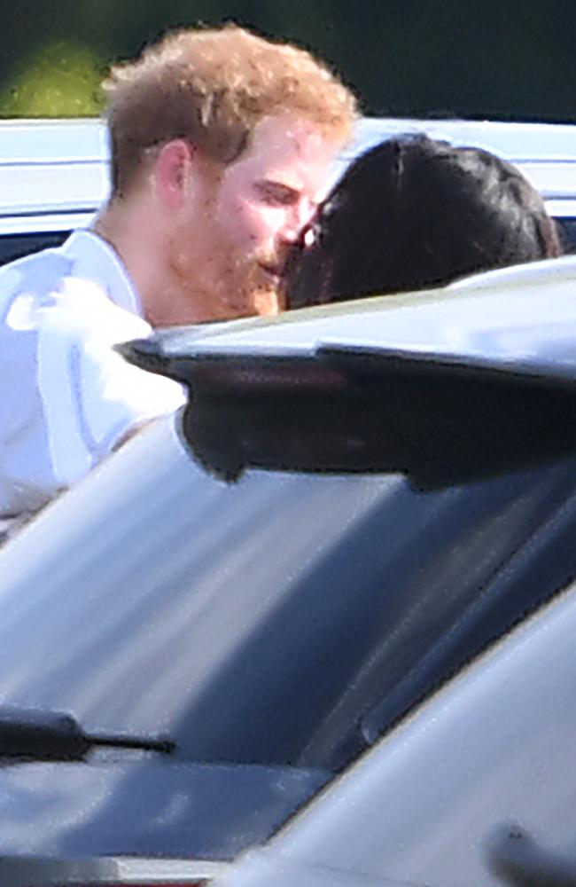 Meghan Markle and Prince Harry kiss and hug after Harry played in the Audi Polo Challenge. Picture: James Whatling/Mega