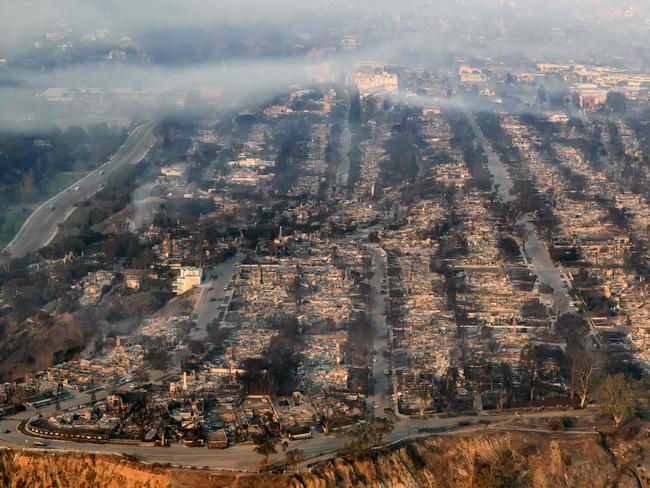 In this aerial view taken from a helicopter, homes burned from the Palisade fire smoulder near the Pacific Palisades neighbourhood of Los Angeles. Pictures: Josh Edelson/AFP