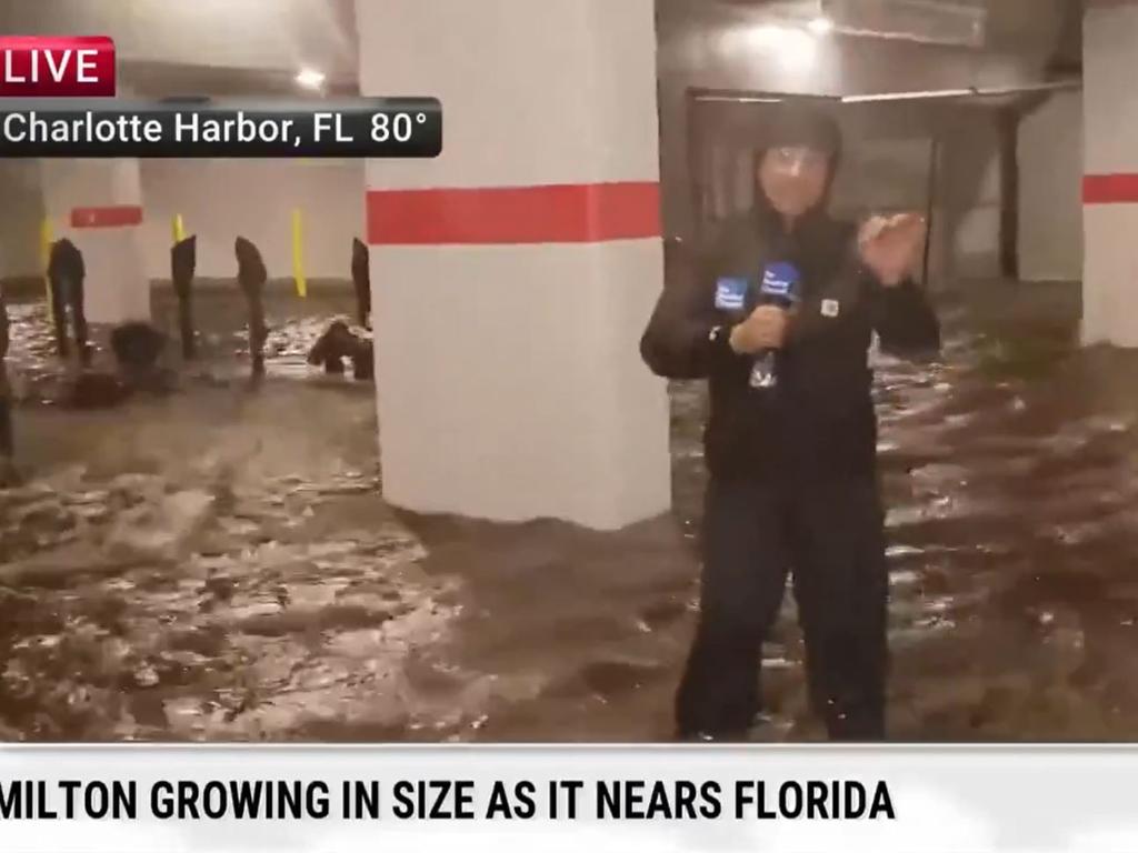 Legendary meteorologist Jim Cantore - dubbed Chuck Norris by some fans - stood in a flooded carpark as a storm surge hit. Picture: The Weather Channel