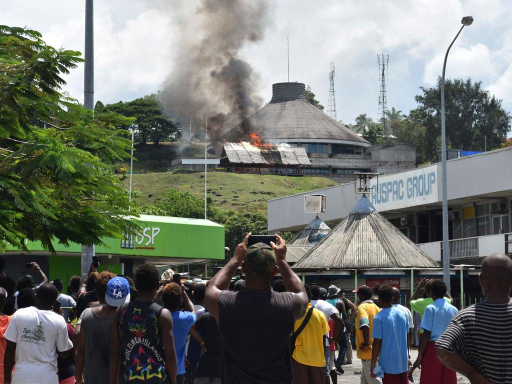 A building burning next to the parliament building in Honiara on Solomon Islands. Picture: Courtesy of Charley Piringi / AFP