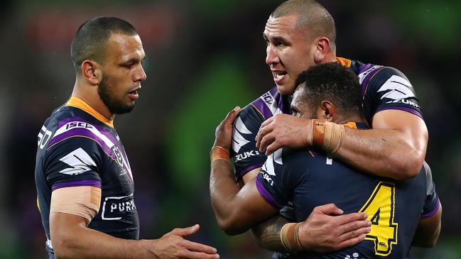 Nelson Asofa-Solomona, Justin Olam and Will Chambers celebrate Storm’s win.