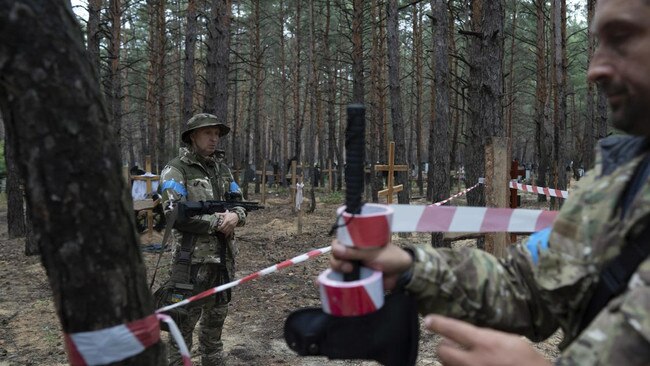 The bodies are expected to be exhumed and sent for forensic examination. Picture: Evgeniy Maloletka/AP/The Times