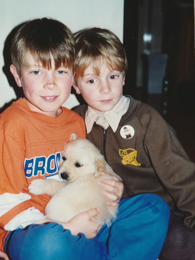 Nic Newling (now 27) and his late brother Christopher who is holding Shadow, their golden retriever.