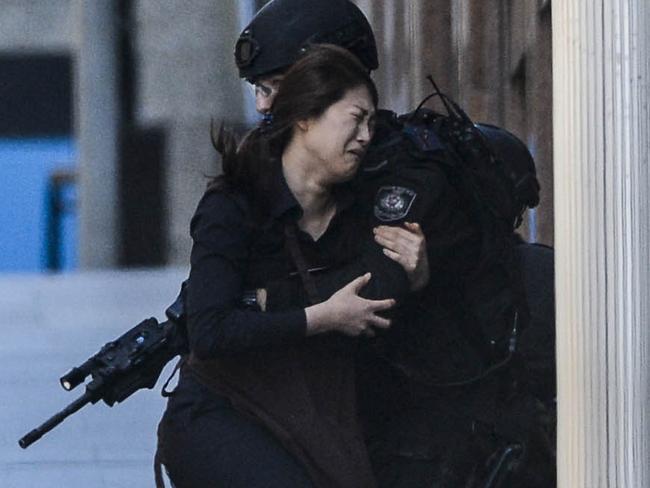 Hostage Elly Chen runs into the arms of police. Picture: Adam Taylor