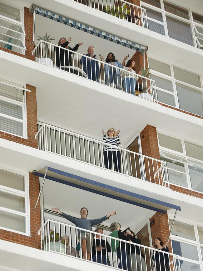 Each sunday just before sunset, residents joined a guided sing-a-long from their balconies. Picture: John Appleyard